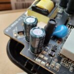 Inspección visual de los condensadores del Xiaomi Mi WiFi Repeater Pro en la fuente de alimentación.